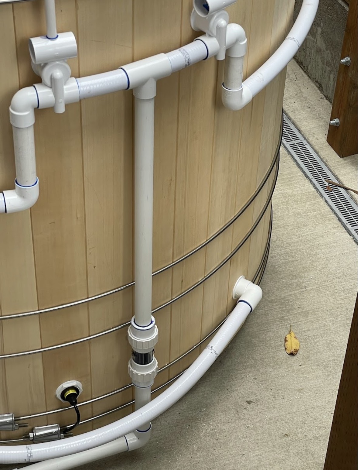 Close-up of PVC plumbing pipework on a cedar hot tub installation